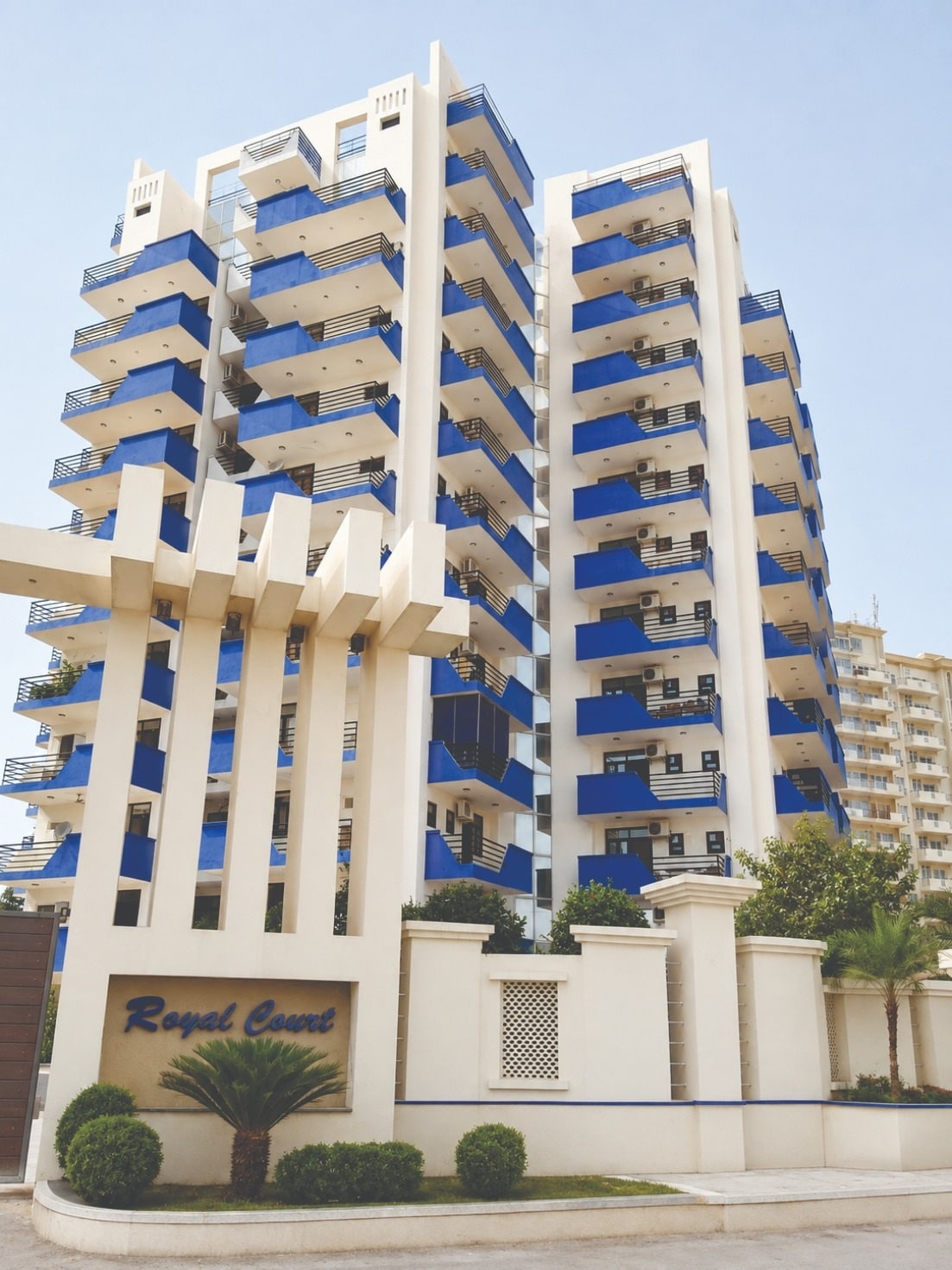 Royal Court tower with signature blue balconies and white colonnade in Sector 39, Gurugram